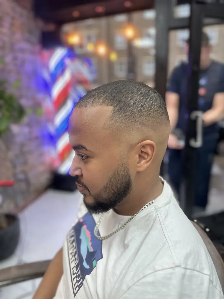 Sharp skin fade with barber pole reflected in the mirror